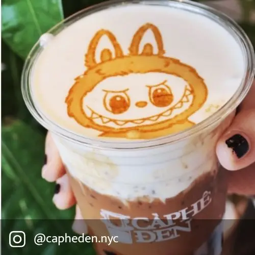 Caphe Den cold foam iced coffee topped with labubu art